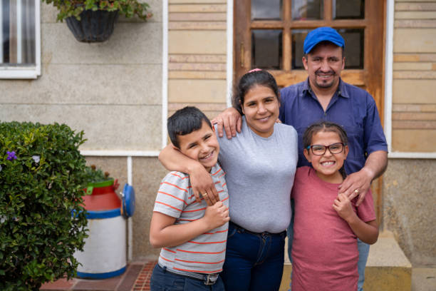 Image of a family in front of their home
